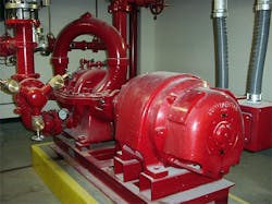 Red fire pump motor and piping system in equipment room