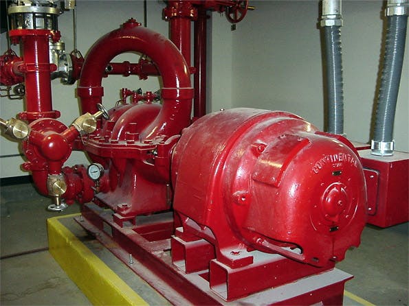 Red fire pump motor and piping system in equipment room