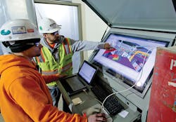 Faith Technologies electricians review a model in the field using BIM in a Box.