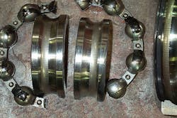 Photo 1. Wear paths offset in opposite directions on inner versus outer race indicate the bearing was preloaded during service, and the fluting indicates electrical discharges — “shaft currents.” Photo 1. Wear paths offset in opposite directions on inner versus outer race indicate the bearing was preloaded during service, and the fluting indicates electrical discharges — “shaft currents.”