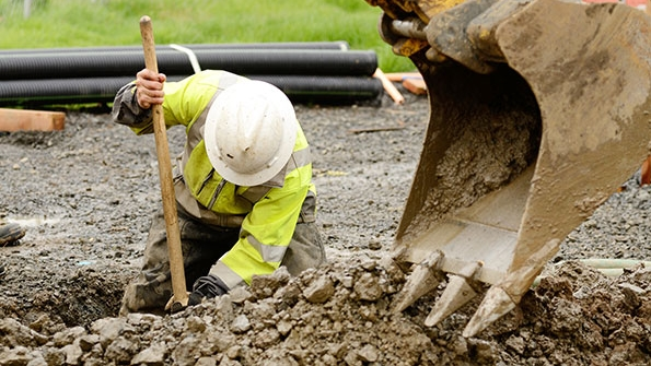 construction working digging trench