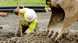 construction working digging trench