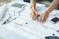 architect drawing a blueprint architect drawing a blueprint