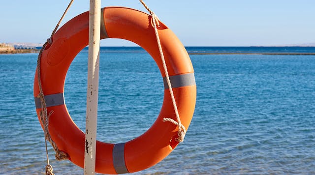 Emergency orange life buoy on sea beach