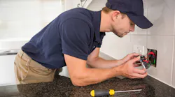 Electrician wiring a receptacle