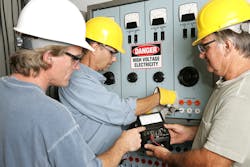 workers at electrical panel workers at electrical panel