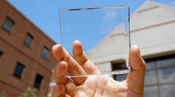 Solar power with a view: MSU doctoral student Yimu Zhao holds up a transparent luminescent solar concentrator module. Photo by Yimu Zhao.