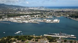 An aerial view of the USS Arizona and USS Missouri Memorials at Ford Island, Joint Base Pearl Harbor-Hickam. Diamond Head, Honolulu and Waikiki are in the distance. (U.S. Navy photo by Mass Communication Specialist Seaman Johans Chavarro/Released)