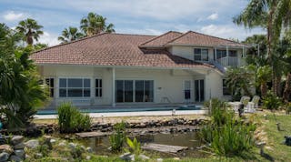 This Merritt Island home will be completely gutted and remodeled during renovations by HGTV. Pictured is an exterior view of the back of the house before renovations.