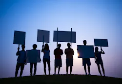 people holding protest signs people holding protest signs