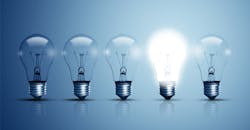 Five light bulbs with one lit up against a blue background. Five light bulbs with one lit up against a blue background.