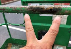 Location where electric current made contact on railing of boom lift basket after arcing from a power line. Location where electric current made contact on railing of boom lift basket after arcing from a power line.