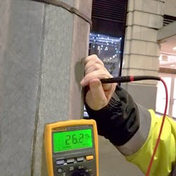 Photo 3. Here, a multimeter is being used to validate that no voltage is present on a light pole. If the voltage detector had indicated the presence of voltage, then the technician would, of course, wear the appropriate gloves prior to taking the measurement.