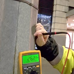 Photo 3. Here, a multimeter is being used to validate that no voltage is present on a light pole. If the voltage detector had indicated the presence of voltage, then the technician would, of course, wear the appropriate gloves prior to taking the measurement. Photo 3. Here, a multimeter is being used to validate that no voltage is present on a light pole. If the voltage detector had indicated the presence of voltage, then the technician would, of course, wear the appropriate gloves prior to taking the measurement.
