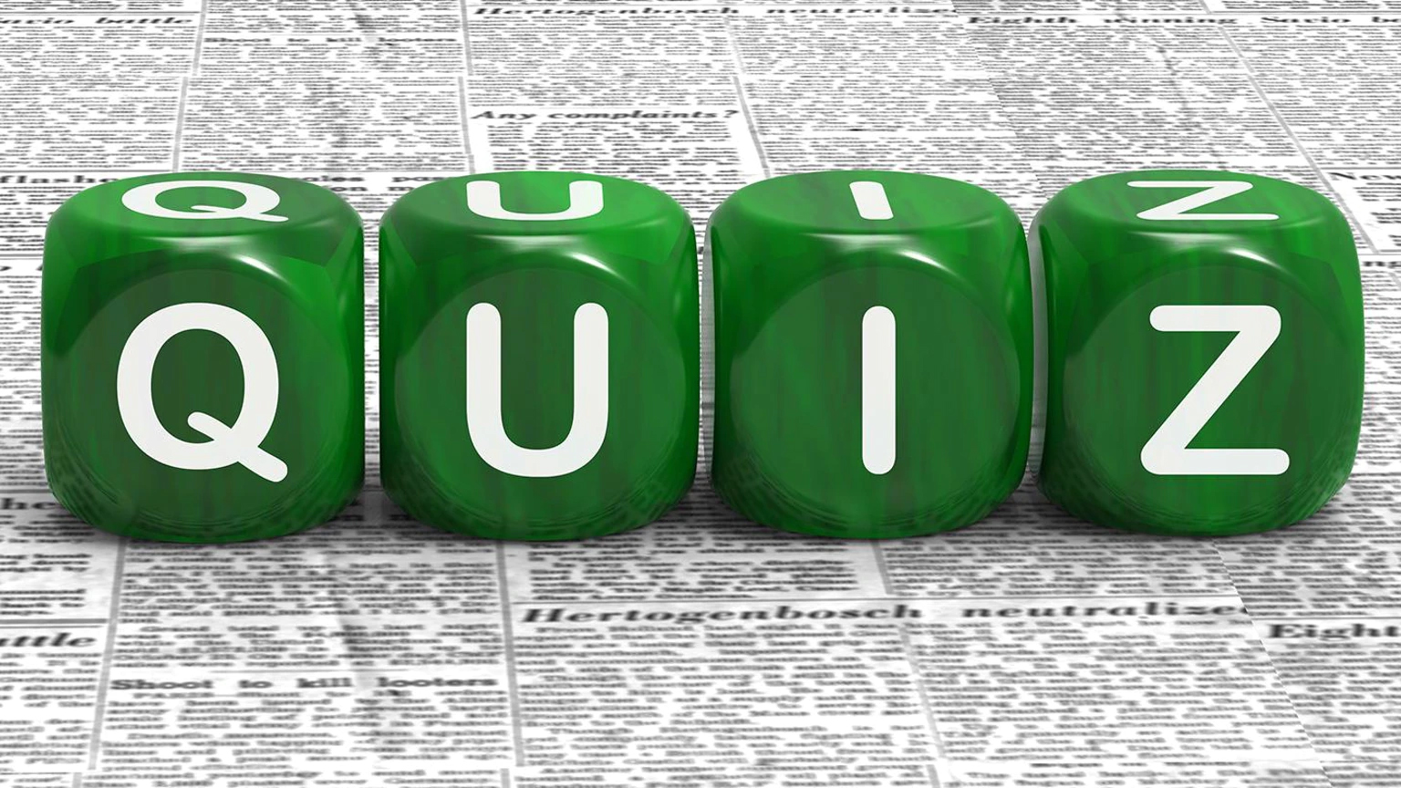 Quiz On Green Dice Sitting On Newspaper 5fa16edb723da
