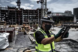 A Power Design foreman captures a photo of an in-progress deck, using an app on his iPad to make real-time field notes. A Power Design foreman captures a photo of an in-progress deck, using an app on his iPad to make real-time field notes.