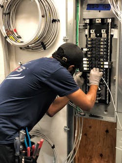 An apprentice with USIS gains experience wiring an electrical panel in the company’s Pearl River, N.Y. prefabrication center. An apprentice with USIS gains experience wiring an electrical panel in the company’s Pearl River, N.Y. prefabrication center.