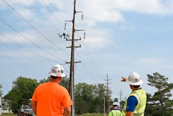 O’Connell's project manager and foreman watch as a pilot team member launches a drone to begin an automated flight on a transmission power line. O’Connell's project manager and foreman watch as a pilot team member launches a drone to begin an automated flight on a transmission power line.