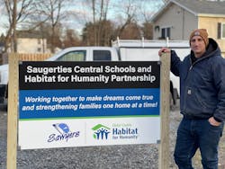 Saugerties Guidance Counselor and Lead Project Advisor Michael Catalano stands in front of a sign by the three homes Ulster BOCES students have volunteered to help build. Saugerties Guidance Counselor and Lead Project Advisor Michael Catalano stands in front of a sign by the three homes Ulster BOCES students have volunteered to help build.