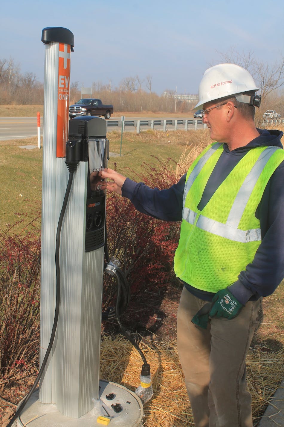 An RJP Electric worker puts the finishing touches on an EV charging station installed at a St. Charles County (Mo.) Economic Development Center facility.