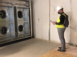 A Dewberry employee uses construction document software to track installation progress on an air-handler system at a hospital.