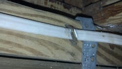 The NM cable staple shown in this photo could be a fire just waiting to happen. The NM cable staple shown in this photo could be a fire just waiting to happen.