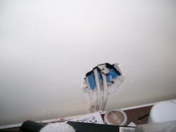 Photo 3. A view of the NM cables that are pinched behind the countertop. Photo 3. A view of the NM cables that are pinched behind the countertop.