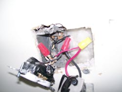 Photo 7. Removing the devices revealed the hacked apart 1-gang box and the installer's method of wiring the thermostat. Photo 7. Removing the devices revealed the hacked apart 1-gang box and the installer's method of wiring the thermostat.
