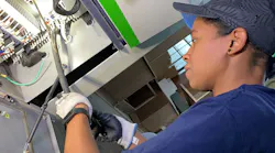 Dana Pinkney, a licensed master electrician, installs a power supply cord to a three-phase commercial edge bander in a commercial cabinetry shop in Philadelphia.