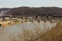 Distant view of a damn on the Monongahela River in Pittsburgh located next to a steel mill.