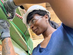 Azzure Ariel Adamme at a wood working shop in Philadelphia wiring a industrial laminator. Azzure Ariel Adamme at a wood working shop in Philadelphia wiring a industrial laminator.