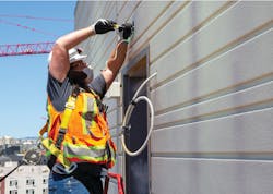 A Cupertino Electric, Inc., employee performs exterior wiring work on Chorus, a 29-floor residential tower in San Francisco, slated for completion in 2021. A Cupertino Electric, Inc., employee performs exterior wiring work on Chorus, a 29-floor residential tower in San Francisco, slated for completion in 2021.