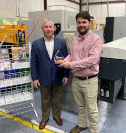EC&amp;M Sales Manager David Sevin (left) presents Matt Strand, president and CEO of Greaves Corp., with the Gold Award trophy for the 2021 Product of the Year.