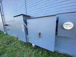 Main electrical service equipment and utility meter on the side of a commercial building Main electrical service equipment and utility meter on the side of a commercial building