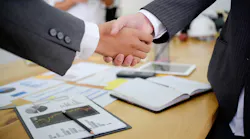 Businessmen In Suits Shaking Hands
