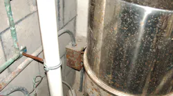 Electrical box on wall behind pool filter container