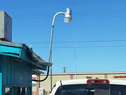 Electrical Metallic Tubing supporting a luminaire on the side of a building