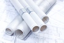 stacked up rolls of construction blueprints