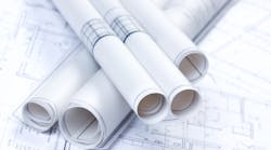 stacked up rolls of construction blueprints