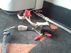 Exposed wiring connections under the HVAC unit in hotel room Exposed wiring connections under the HVAC unit in hotel room