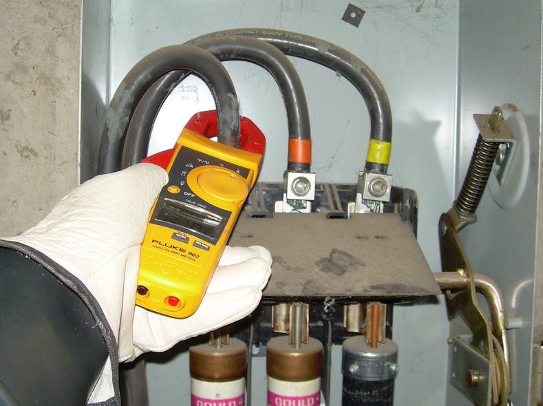 Photo 3. Practice extreme caution when using the clamp function of a multimeter inside of energized cabinets. Perform a visual inspection of conductors and the enclosure before placing the clamp around the conductor. Only one conductor (or phase conductor) can be inside the clamp at one time for accurate measurements.
