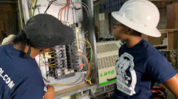 A licensed master electrician and electrical apprentice are working on a 3-phase commercial bolt-on panel and installing a 3-phase industrial edge bander at a woodworking shop in Philadelphia.
