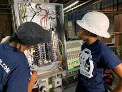 A licensed master electrician and electrical apprentice are working on a 3-phase commercial bolt-on panel and installing a 3-phase industrial edge bander at a woodworking shop in Philadelphia. A licensed master electrician and electrical apprentice are working on a 3-phase commercial bolt-on panel and installing a 3-phase industrial edge bander at a woodworking shop in Philadelphia.