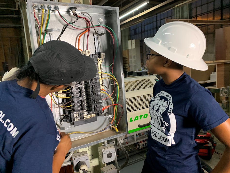 A licensed master electrician and electrical apprentice are working on a 3-phase commercial bolt-on panel and installing a 3-phase industrial edge bander at a woodworking shop in Philadelphia.