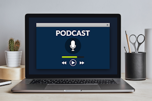 Photo of a podcast playing on a laptop background