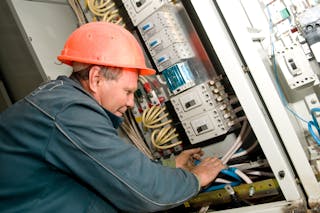 Photo 3. An electrician is terminating control cables to motor control center equipment.