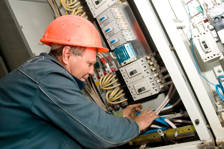Photo 3. An electrician is terminating control cables to motor control center equipment.