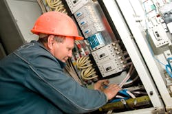 Photo 3. An electrician is terminating control cables to motor control center equipment. Photo 3. An electrician is terminating control cables to motor control center equipment.