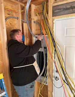 Senior Jonathan Toth worked on tying in the circuits to the 200A load center, after Catalano went over components of the load center and ampacity rating of each cable, so he could terminate to the correct breaker.