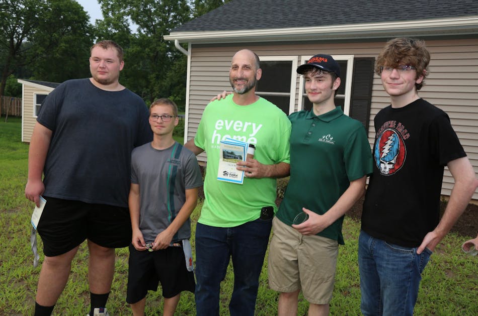 From left to right: Jonathan Toth, Dylan Senor, Catalano, Ian Foster, and Ben Rappoport (a Saugerties High School senior with no electrical background but a heart for volunteering, who worked alongside the BOCES students), attended a celebration to see the completed home and meet the family receiving the keys.